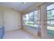 The sun room features beautiful windows with views of the yard, and tile flooring at 1655 S Highland Ave # B110, Clearwater, FL 33756