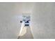 Long walkway between white textured walls leads to parking lot at 1655 S Highland Ave # B110, Clearwater, FL 33756