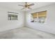 Clean bedroom featuring two large windows, a ceiling fan, and awaiting personal touches for customization at 1910 Rainbow Dr, Clearwater, FL 33765