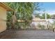Exterior view of a deck with weathered wood and lush greenery beyond the railing at 1910 Rainbow Dr, Clearwater, FL 33765