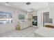 Bright kitchen offers tile flooring, generous counter space, and well lit with natural sunlight from surrounding windows at 1910 Rainbow Dr, Clearwater, FL 33765
