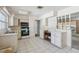 A bright kitchen features white appliances, tile floors, and ample cabinet space for storage at 1910 Rainbow Dr, Clearwater, FL 33765