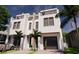 Rendering of a modern three-story home featuring balconies, a two-car garage, with stone accents and manicured landscaping at 306 S Albany Ave, Tampa, FL 33606