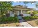 Inviting home with a welcoming porch supported by classic columns, complemented by lush greenery and a cozy atmosphere at 306 S Albany Ave, Tampa, FL 33606