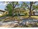 Charming house featuring a covered front porch with classic columns, a well-maintained lawn, and mature trees at 306 S Albany Ave, Tampa, FL 33606