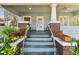 Inviting front porch featuring classic columns, lush plants, and a welcoming entrance with steps leading to the front door at 306 S Albany Ave, Tampa, FL 33606