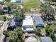 Clear view of a house with a bright white roof next to a fenced yard and playground at 3106 Lila St, Tampa, FL 33610