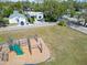 Bright aerial view of property including playground, lawn, and surrounding neighborhood homes at 3106 Lila St, Tampa, FL 33610