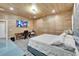 Well-lit bedroom has a large bed, desk area, closet and a large screen television at 3106 Lila St, Tampa, FL 33610