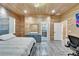 Spacious bedroom with wood paneled walls, luxury bed, dresser and ensuite bath at 3106 Lila St, Tampa, FL 33610