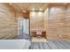 Well lit bedroom with light wood paneling and gray wood look floors at 3106 Lila St, Tampa, FL 33610