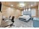 Spacious bedroom with wood paneled walls, office area, luxury bed and stone accent wall at 3106 Lila St, Tampa, FL 33610