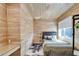 Cozy bedroom with wood-paneled walls and a modern hanging desk at 3106 Lila St, Tampa, FL 33610