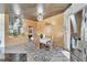 Dining room with wood paneling, statement lighting, and modern decor, adjacent to kitchen with stainless steel appliances at 3106 Lila St, Tampa, FL 33610