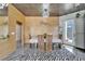 Dining room with modern lighting, wood paneling, marble accent, and a view to outdoor space at 3106 Lila St, Tampa, FL 33610