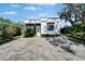 Charming home featuring modern brickwork, wood accents, neat landscaping, and a stylish brick driveway at 3106 Lila St, Tampa, FL 33610