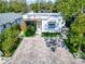 Aerial view of the stylish single-story home, highlighting the modern architecture and the well-maintained front yard at 3106 Lila St, Tampa, FL 33610