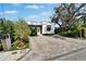 Charming home featuring modern brickwork, wood accents, neat landscaping, and a stylish brick driveway at 3106 Lila St, Tampa, FL 33610