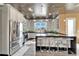 Bright kitchen features stainless steel appliances, marble accents, an island with seating and pendant lighting at 3106 Lila St, Tampa, FL 33610