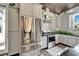 Modern kitchen with stainless steel refrigerator, matching oven, granite countertops, white cabinets, and unique decor at 3106 Lila St, Tampa, FL 33610