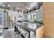 Modern kitchen features marble accents, stainless steel appliances, a central island with seating and pendant lighting at 3106 Lila St, Tampa, FL 33610
