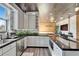 Modern kitchen with stainless steel appliances, white cabinets, dark countertops, and natural light at 3106 Lila St, Tampa, FL 33610