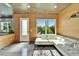 Cozy living area with wood accents, white sofa, and view into the backyard at 3106 Lila St, Tampa, FL 33610