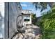 Side of home featuring modern brickwork, wood accents, neat landscaping, and a stylish brick driveway at 3106 Lila St, Tampa, FL 33610