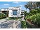 Side of home featuring modern brickwork, wood accents, neat landscaping, and a stylish brick driveway at 3106 Lila St, Tampa, FL 33610