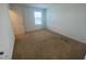 Bright, carpeted bedroom with a window at 35220 White Water Lily Way, Zephyrhills, FL 33541