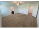 Spacious bedroom with carpeted floors, ceiling fan, and access to a bathroom and closet at 35220 White Water Lily Way, Zephyrhills, FL 33541