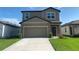 Charming two-story home with a well-manicured lawn and a spacious two-car garage at 35220 White Water Lily Way, Zephyrhills, FL 33541