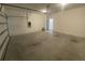 Large empty garage with a sealed concrete floor at 35220 White Water Lily Way, Zephyrhills, FL 33541