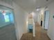 Hallway with carpeted floors leading to several rooms including bedrooms and a bathroom at 35220 White Water Lily Way, Zephyrhills, FL 33541