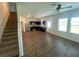Open-concept living area with modern flooring, ceiling fan, and adjacent kitchen at 35220 White Water Lily Way, Zephyrhills, FL 33541