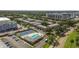 Aerial view of community featuring a pool, tennis courts, mature landscaping and ample parking at 3824 37Th S St # 65, St Petersburg, FL 33711