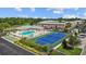 Aerial view showcasing the community pool, tennis court, and well-maintained brick apartment buildings at 3824 37Th S St # 65, St Petersburg, FL 33711