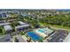 Community aerial view featuring amenities like a tennis court and pool surrounded by greenery at 3824 37Th S St # 65, St Petersburg, FL 33711