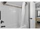 Well-lit tub and shower combo featuring stylish tile and updated matte black hardware at 3824 37Th S St # 65, St Petersburg, FL 33711