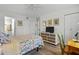 Well-appointed bedroom with a ceiling fan, features a dresser and a dedicated desk area, blending comfort and functionality at 3824 37Th S St # 65, St Petersburg, FL 33711