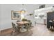 Cozy dining area with stylish furnishings, hardwood floors, and an open view into the kitchen at 3824 37Th S St # 65, St Petersburg, FL 33711