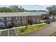 A two-story brick condo building features well-maintained landscaping and ample parking space at 3824 37Th S St # 65, St Petersburg, FL 33711