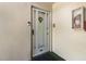 Welcoming condo front door featuring a storm door, unit number, and a decorative wreath for added curb appeal at 3824 37Th S St # 65, St Petersburg, FL 33711