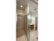 Bathroom with tile floors, tiled shower with glass doors, and a vanity with sink at 415 Bayou Village Dr, Tarpon Springs, FL 34689