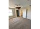 Bedroom showing carpeted floors and a walk-in closet at 415 Bayou Village Dr, Tarpon Springs, FL 34689