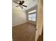Bedroom with wood floors, neutral paint, ceiling fan, and natural light at 415 Bayou Village Dr, Tarpon Springs, FL 34689