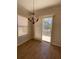 Bright dining area with wood floors, chandelier, and sliding door to balcony with water view at 415 Bayou Village Dr, Tarpon Springs, FL 34689