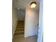 Entryway with tile floor, light fixture, door and staircase to upper floor at 415 Bayou Village Dr, Tarpon Springs, FL 34689