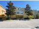 Inviting multi-story yellow condo with well-maintained landscaping and a bright, sunny facade at 415 Bayou Village Dr, Tarpon Springs, FL 34689