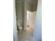 Half bath features tile flooring, toilet and view of the home at 415 Bayou Village Dr, Tarpon Springs, FL 34689